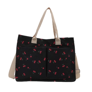 Black canvas tote bag with red cherry prints and white straps for women