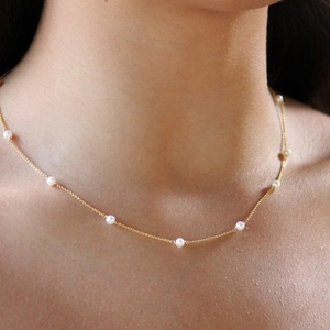 Elegant S925 silver pearl necklace with gold chain shown on a model neck