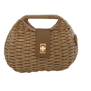 Fashionable khaki woven straw handbag with brown leather flap and golden twist lock