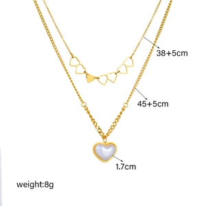 Double layer gold necklace with hollow heart pendants and pearl chain details