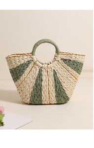 Detail of straw woven tote bag featuring gold thread, striped patterns, and round handle
