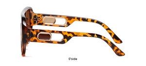Detail of tortoise shell sunglasses with gold hollow decoration and brown lenses