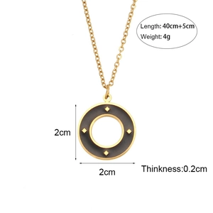 Minimalist gold necklace with black enamel circle pendant featuring four star patterns