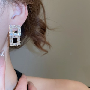 Close-up of elegant 18K gold-plated double rectangle stud earrings with zircon stones