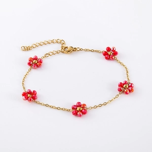 Detail of gold chain bracelet with five red beaded flowers and adjustable lobster clasp