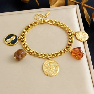 Vintage gold-plated link chain bracelet with religious coin charms and amber resin stones