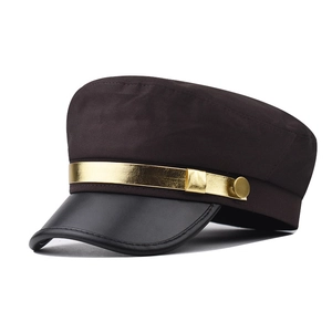 Détail d'une casquette vintage avec bord en cuir brillant et garniture dorée élégante