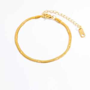 Macro shot of 18k gold plated snake chain bracelet with star texture and lobster clasp