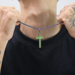 Close-up of rainbow gradient stainless steel cross pendant necklace worn on neck