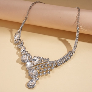 Macro shot of silver-tone teardrop crystal necklace with detailed V-shaped diamond settings