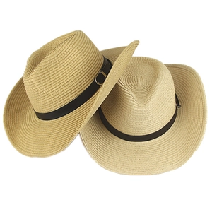 Detail of western straw cowboy hats with wide brim and leather bands on white background