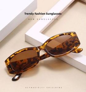 Close-up of retro tortoiseshell oval sunglasses with brown lenses and premium frame