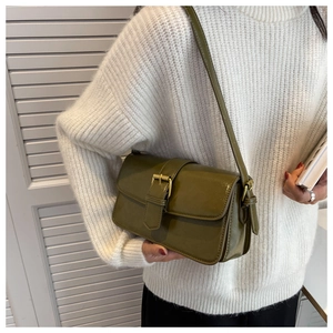 Olive green vintage flap bag detail showing glossy leather and golden buckle accent