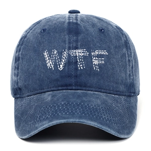 Vintage washed dark blue denim baseball cap with white WTF embroidery on a white background
