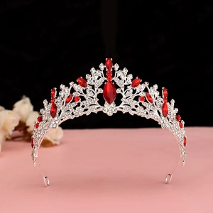 Detail of silver bridal crown with radiant red gemstones and shimmering crystals