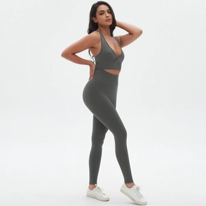 Detail view of seamless dark grey yoga set with V-neck cross design and high waist leggings