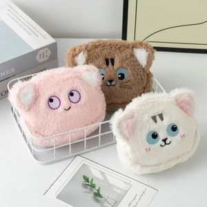 Tre portamonete a forma di orsetto in peluche rosa, marrone e crema in un cestino bianco