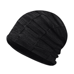 Detail of the black basket-weave knit pattern on a thick winter beanie hat