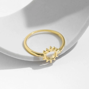 Minimalist s925 silver golden sun-shaped hollow ring on geometric stone background