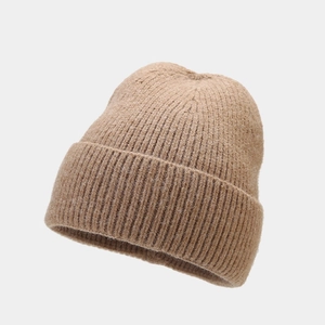 Detailed knit texture and folded cuff of a warm camel beanie for autumn and winter