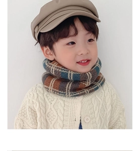 Close-up of children's knit neck warmer in vintage brown and blue plaid pattern