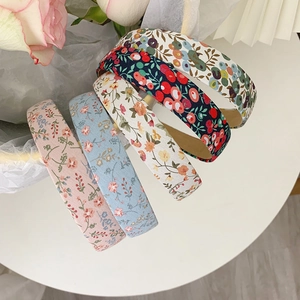 Floral and plaid fabric headbands set in pink blue and navy blue on a white table