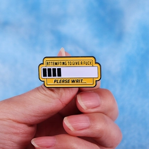Funny enamel pin with Attempting to Give a Fuck text and loading bar design held by hand