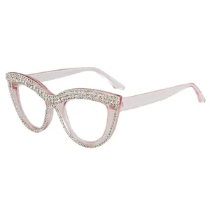 Pink cat eye reading glasses with rhinestone embellishments on a white background