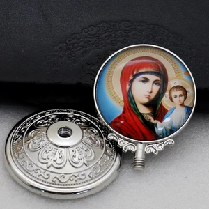 Macro view showing both sides of a silver metal Orthodox pendant with Virgin and Child icon