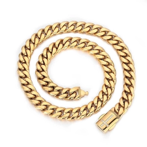 Detail of gold Cuban link chain necklace with a zircon-encrusted cross buckle fastener