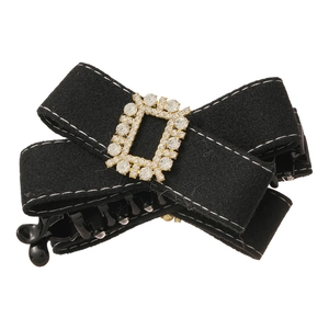 Elegant black fabric bow hair clip with sparkling rhinestone buckle on a white background