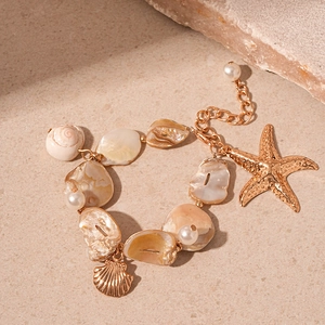 Close-up of ocean-style necklace with starfish, shells, and faux pearl charms