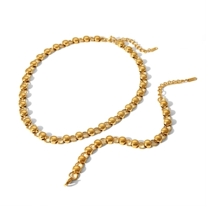 Detail of gold beaded necklace featuring adjustable extender chain and lobster clasp