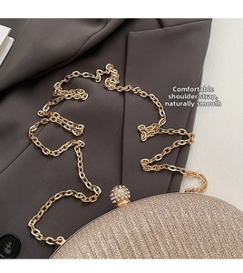 Detail of champagne gold evening clutch with glitter texture and crystal ball clasp