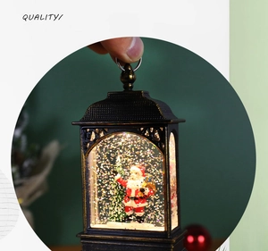 Detailed view of bronze Christmas lantern with Santa scene and swirling glitter interior