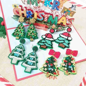Detail of four handmade beaded Christmas tree earrings with colorful rhinestones and beads