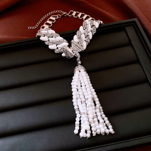 Macro detail of luxury vintage pearl tassel necklace with sparkling rhinestones in a gift box