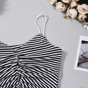 Detail of striped halter top featuring ruched chest design and thin spaghetti straps