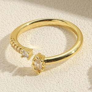 Macro shot of gold adjustable ring featuring marquise and square cut cubic zirconia gems