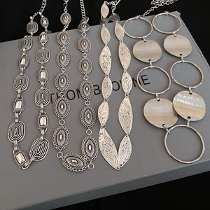 Close-up of vintage silver bohemian waist chains with oval and leaf metal links