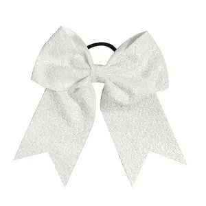 Detail view of large white sequin bow hair tie with high-elastic black rubber band