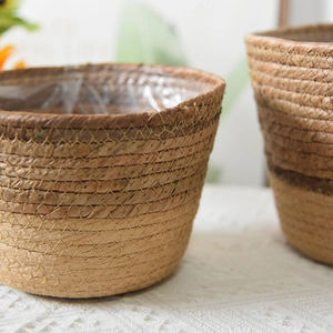 Detail of hand-woven seagrass basket featuring waterproof plastic liner and natural texture