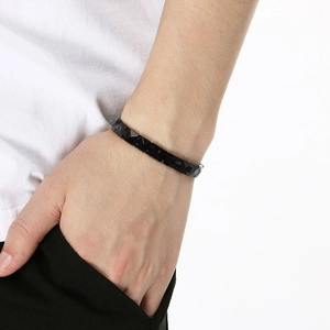 Close-up of men's black tungsten steel bracelet with geometric faceted texture on wrist