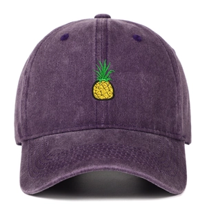Detail of yellow pineapple embroidery on purple washed cotton baseball cap