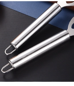 Close-up of the brushed stainless steel handle with hanging loop on this kitchen peeler tool