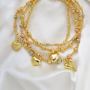 Three-tone beaded heart necklace featuring gold, silver, and rose gold metallic spheres