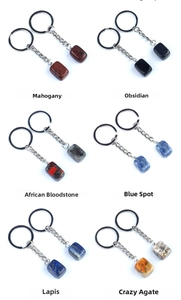 Macro detail of six varieties of polished 16mm rectangular natural stone keychains