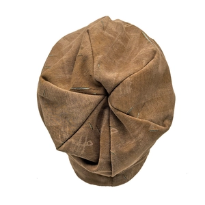 Top view of brown vintage distressed beanie with ripped texture and washed canvas material