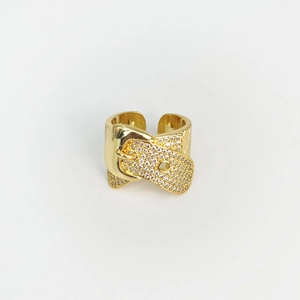 Macro shot of gold belt buckle ring with crystal pavé setting on white background