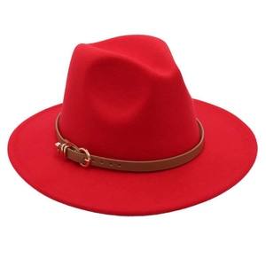 Detail of red wool fedora hat featuring a stylish brown leather band and metal buckle strap